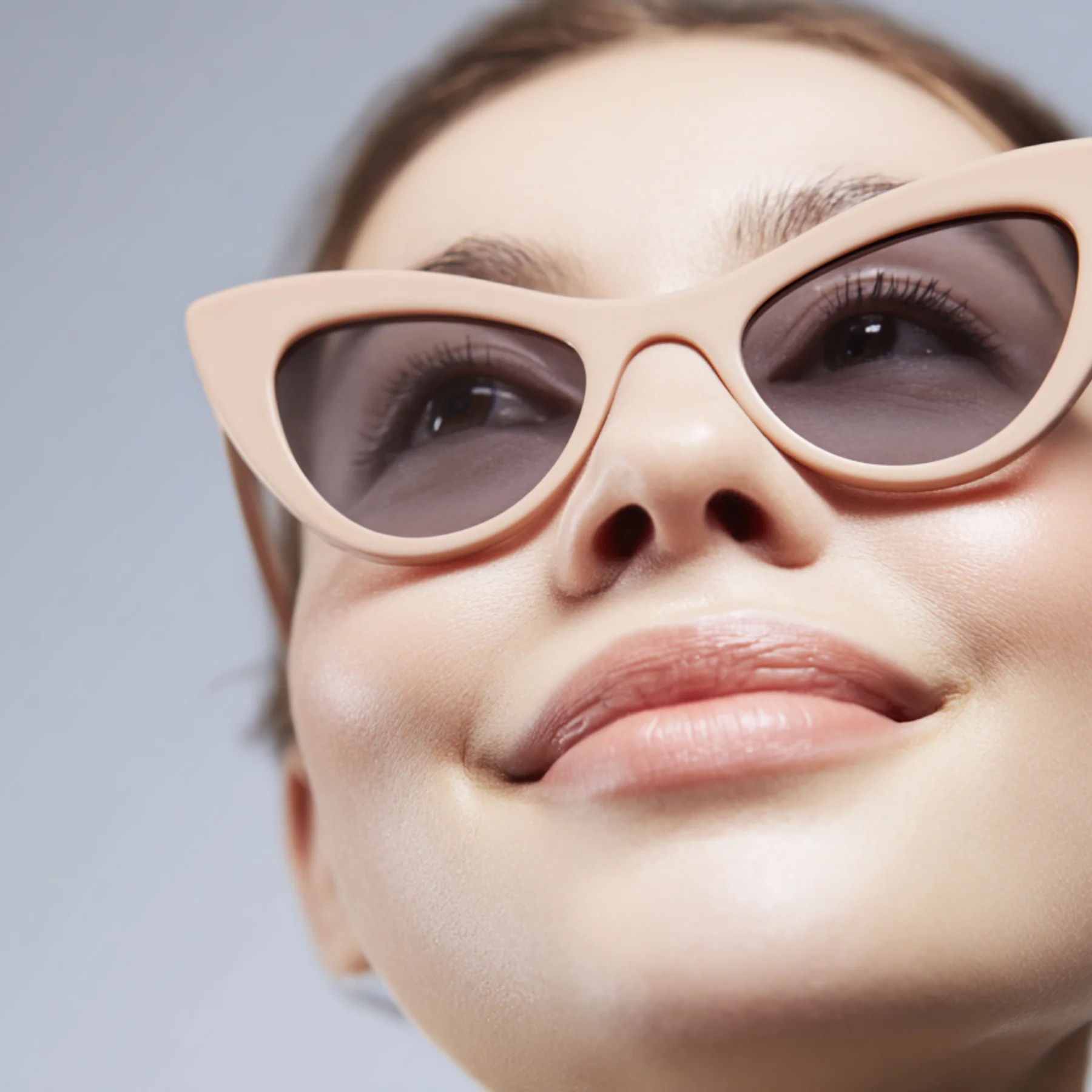Style identity expressed through accessories — a woman wearing cat-eye sunglasses with quiet confidence